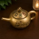 Tetera Feng Shui giratoria de cobre con moneda de la prosperidad