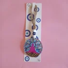 AMULETO PROTECCIÓN DE CUERDA Y GAUTUM BUDA EN VIDRIO CON OJO TURCO 23 X 8 CM