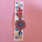 1012091 CHARM DE MADERA CON CAMPANA Y OJO TURCO 28 X 8 CM